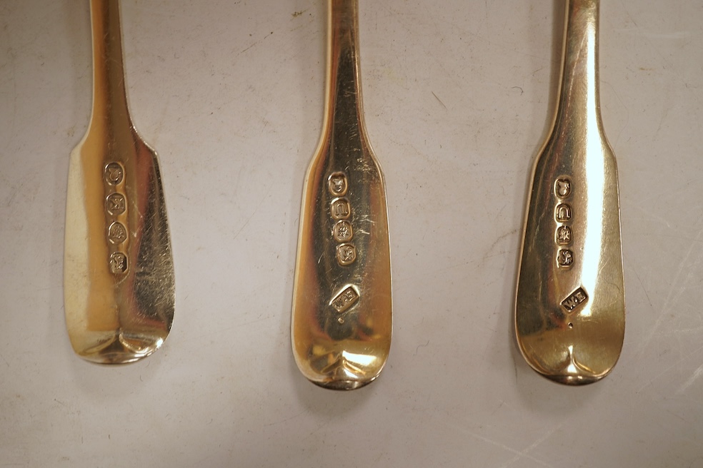 A matched set of six George III silver fiddle pattern dessert spoons, including five by William Eaton, London, 1815, 8oz.